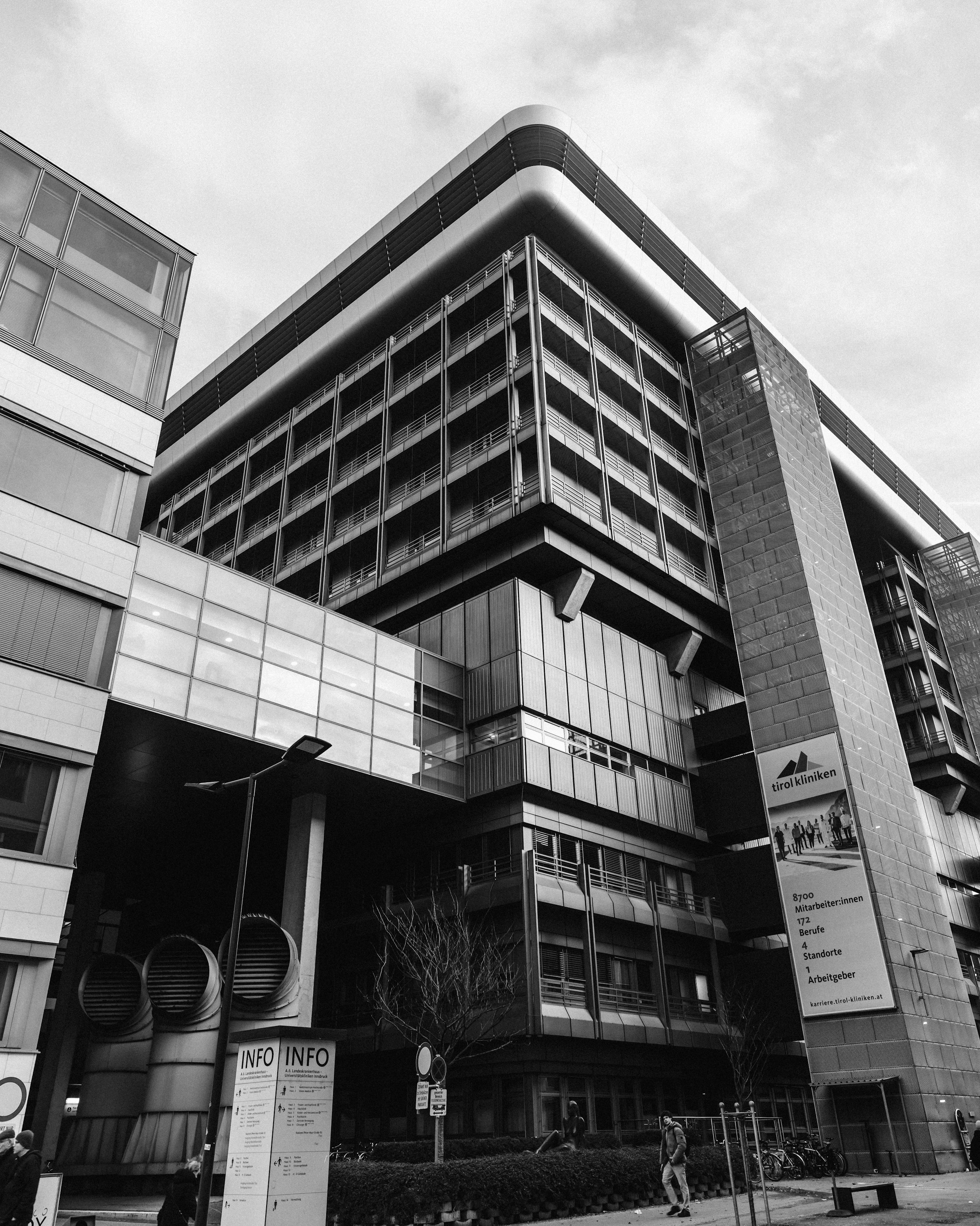 A black and white photo of a large building by Florian Schindler