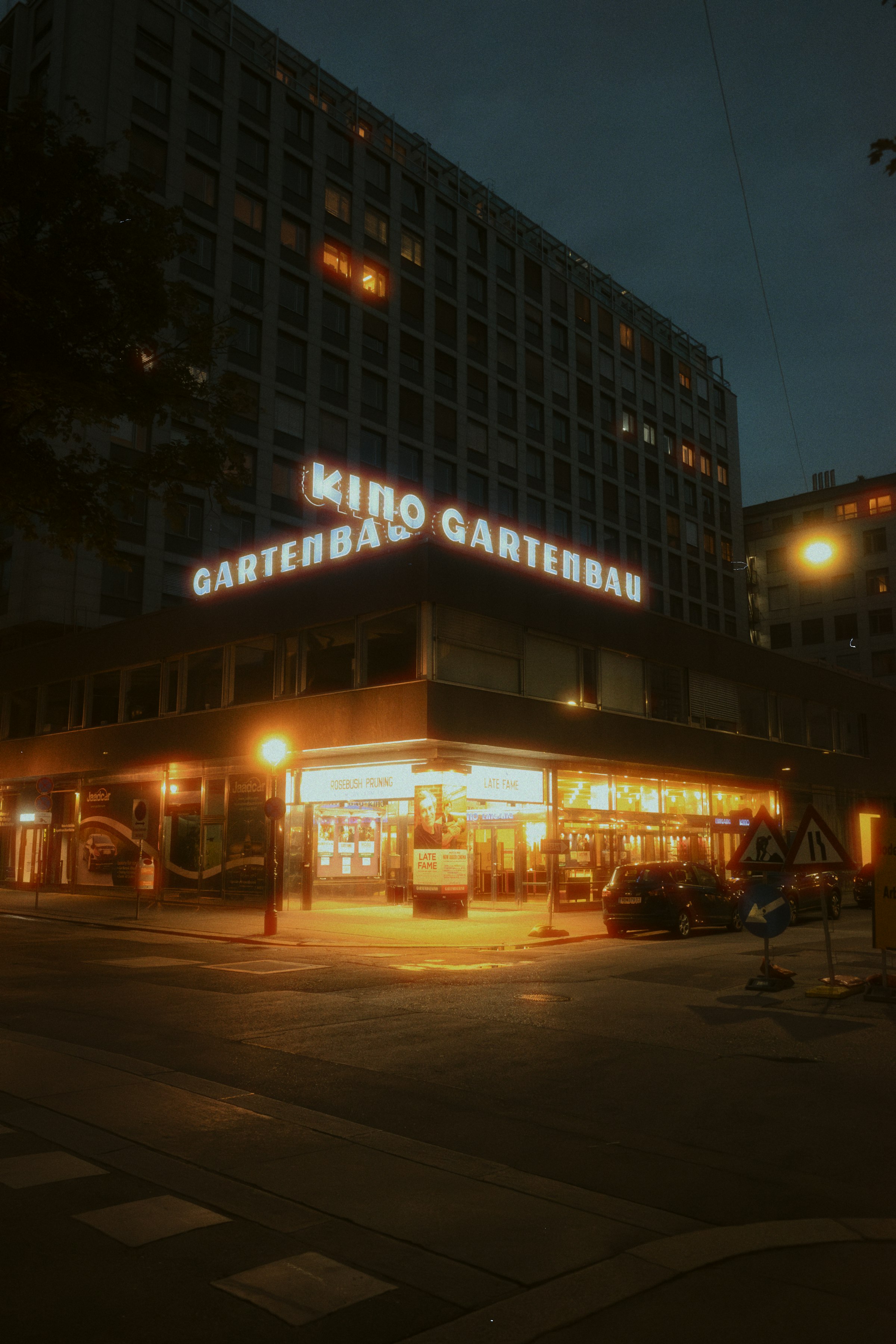 The illuminated Kino Gartenbau cinema at night by Florian Schindler