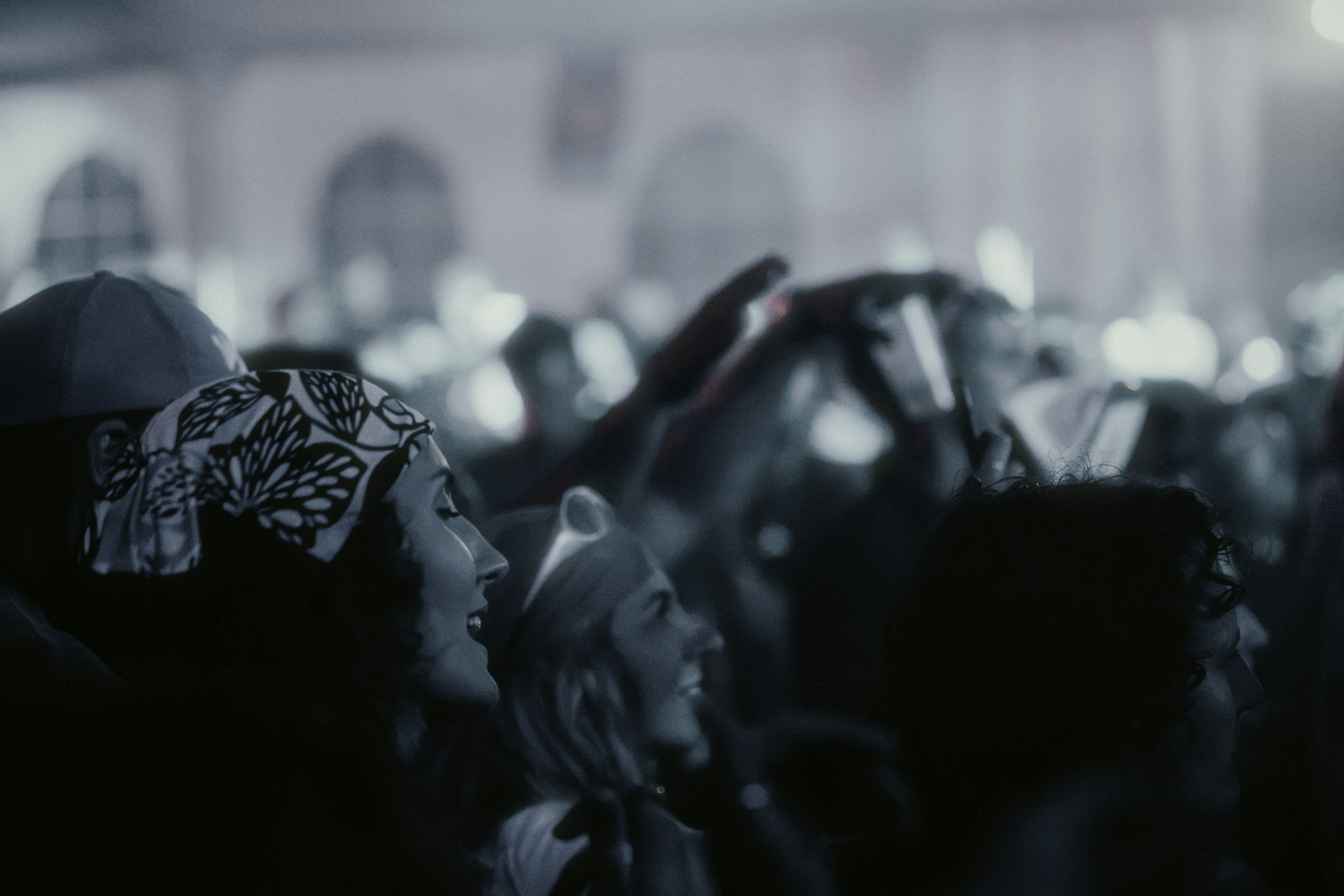 Enthusiastic crowd in a dark venue by Florian Schindler