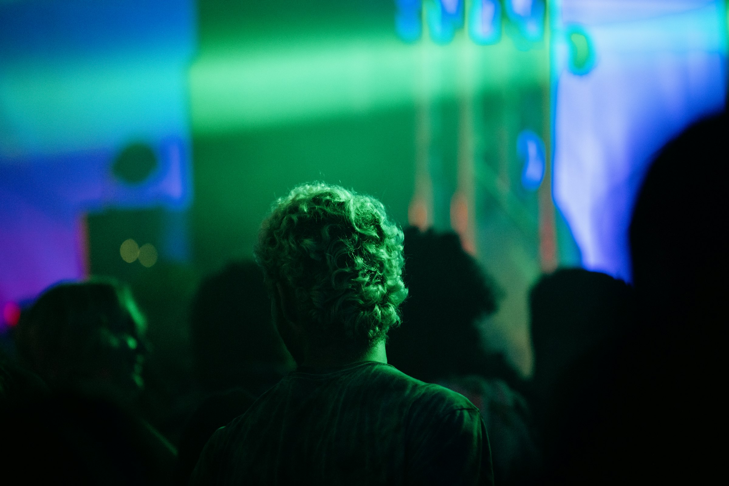 Audience watching a colourful light show by Florian Schindler