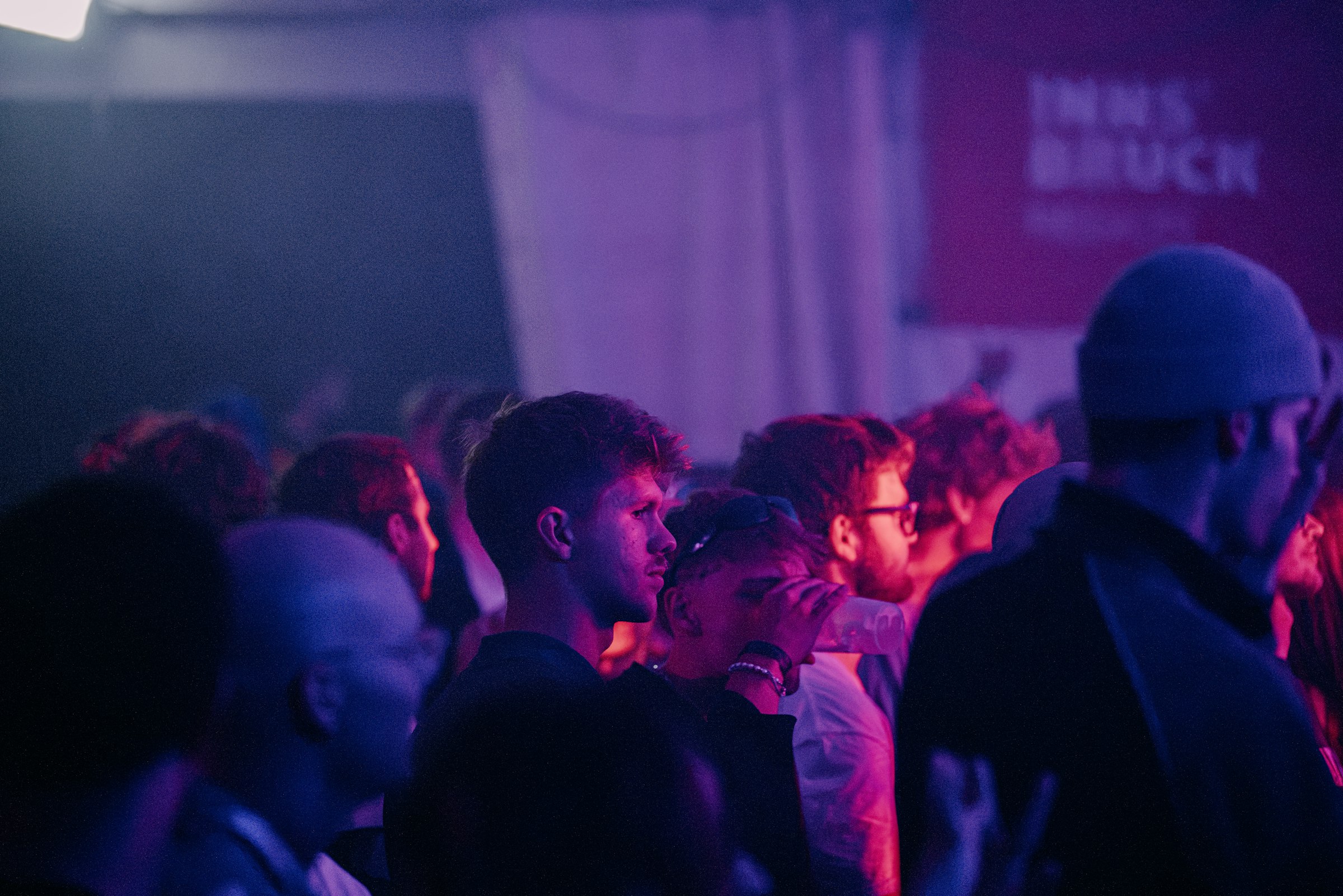 A dim purple-lit indoor event by Florian Schindler