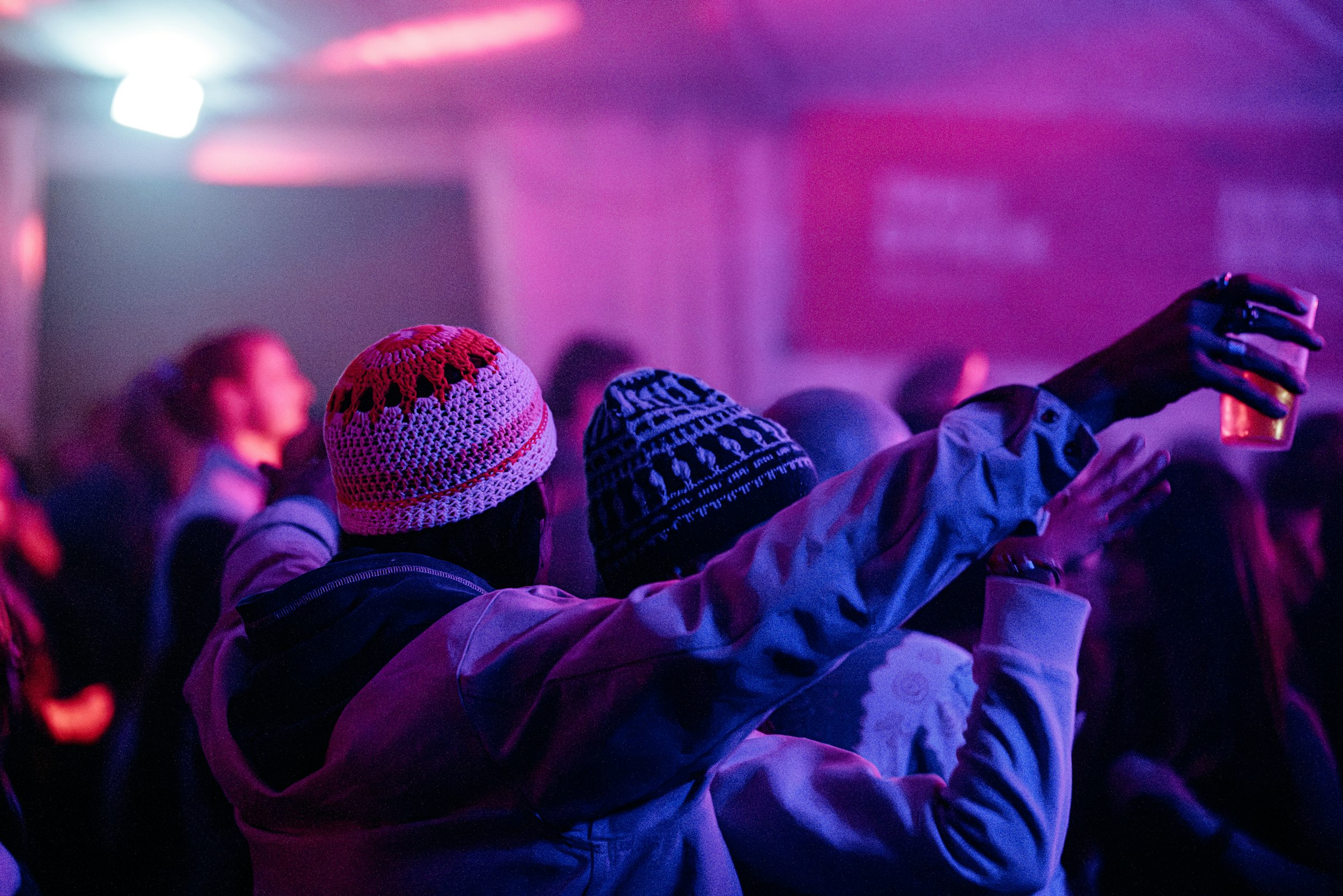 Two people at a concert under violet lights by Florian Schindler